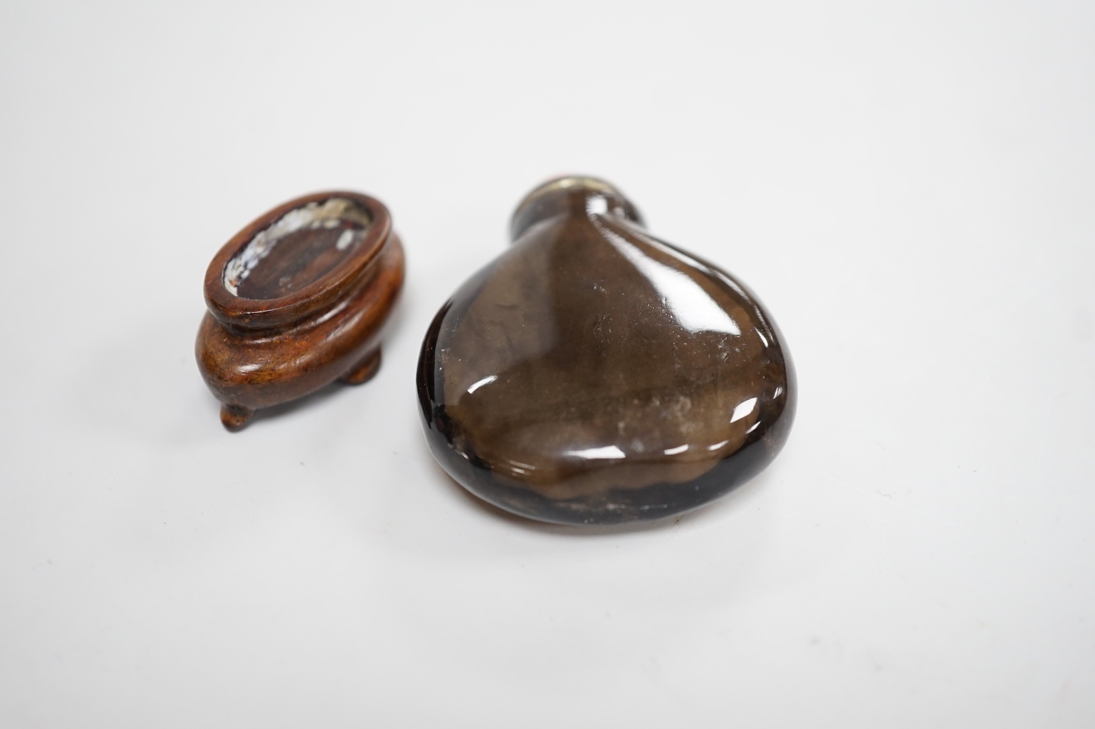 A Chinese smoky quartz snuff bottle, 18th/19th century, well hollowed, 4.7cm, coral stopper